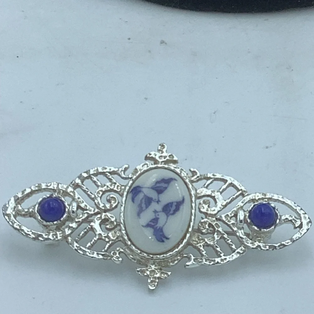 Silver-Tone Filigree Brooch with Blue/White Bird Design